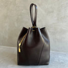 Brown leather handbag with gold accents